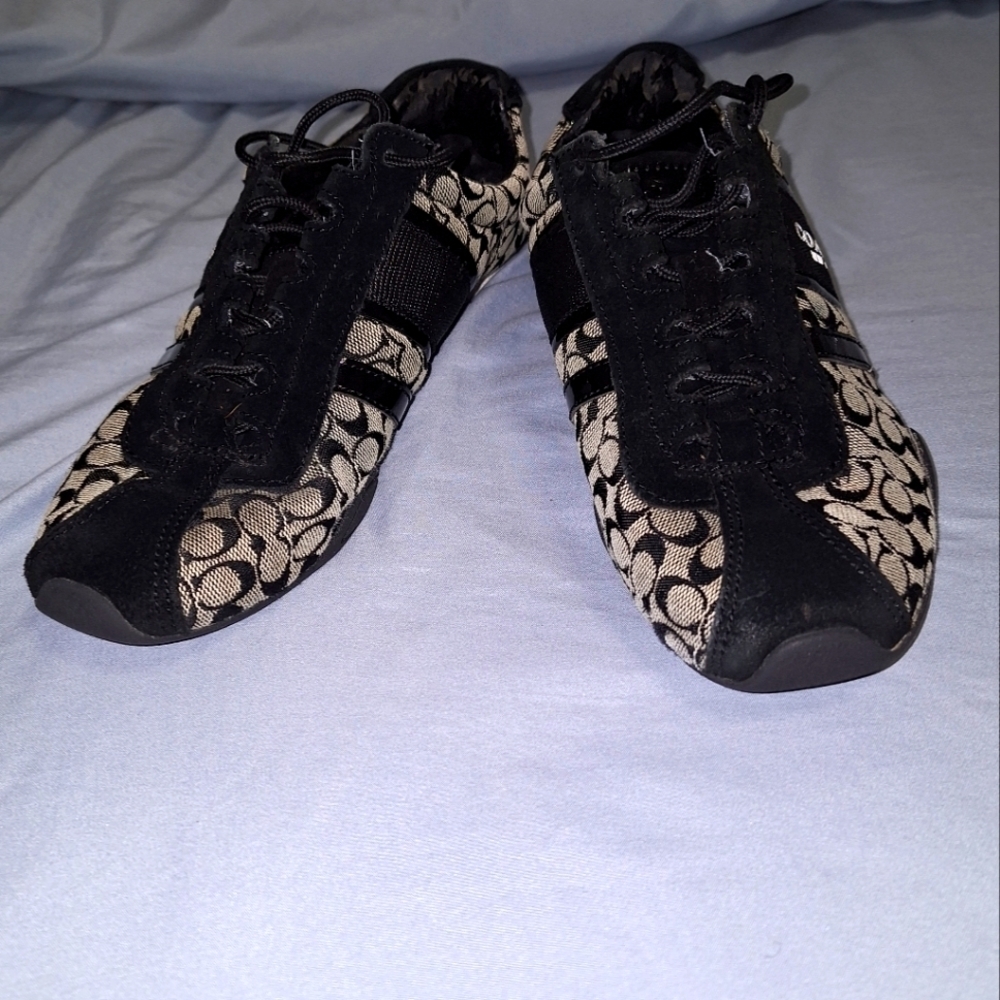 A pair of Coach sneakers in a ladies size 7.5B. Pre-loved with some flaws